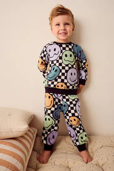 |Niño| Pijama único de forro polar suave al tacto con spandex – Cara sonriente de tablero de ajedrez neutro/negro (de 9 meses a 12 años)